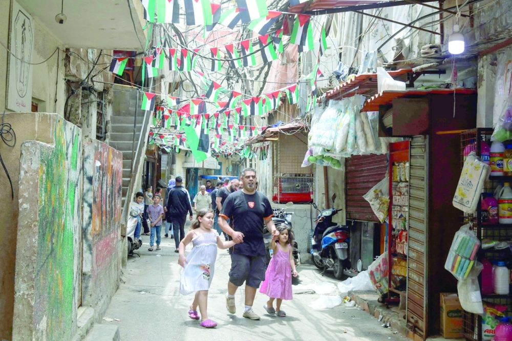 A man walks alongside girls in Beirut. AFP
