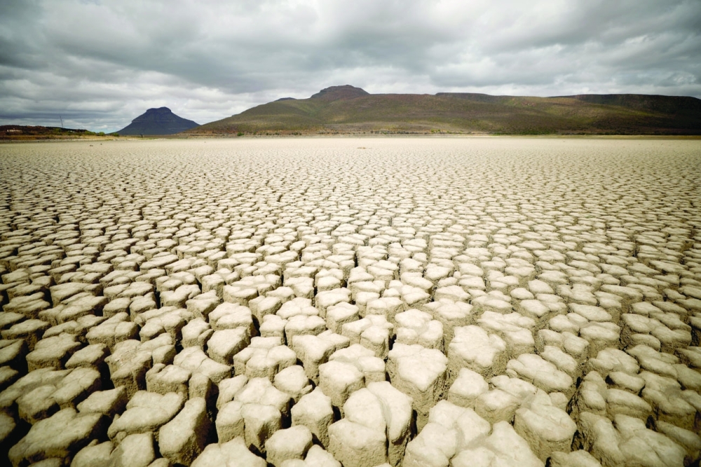 Clouds gather but produce no rain as cracks are seen in the dried-up municipal dam in drought-stricken Graaff-Reinet, South Africa, on November 14, 2019. 