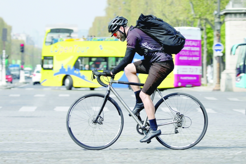 A cycling courier delivers goods, as part of the emerging 'gig economy', in Paris, France. - Reuter File Photo
