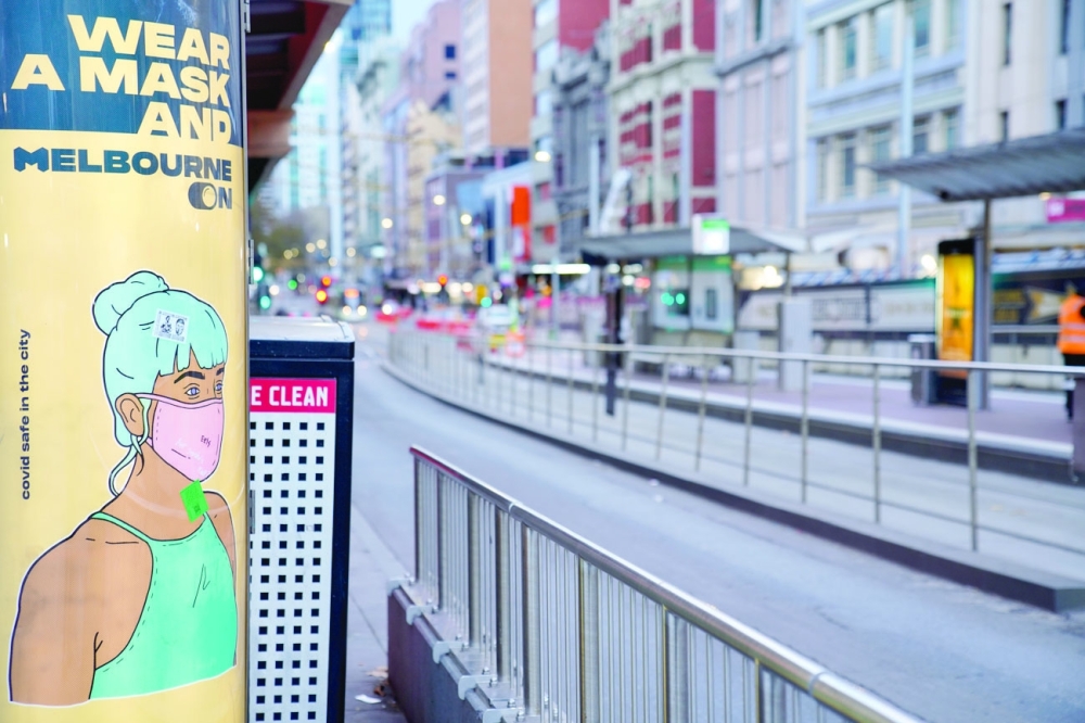 A 'Wear a Mask' sign is seen on a mostly-empty city street on the first day of a seven-day lockdown as the state of Victoria looks to curb the spread of a coronavirus disease outbreak in Melbourne. - Reuters 