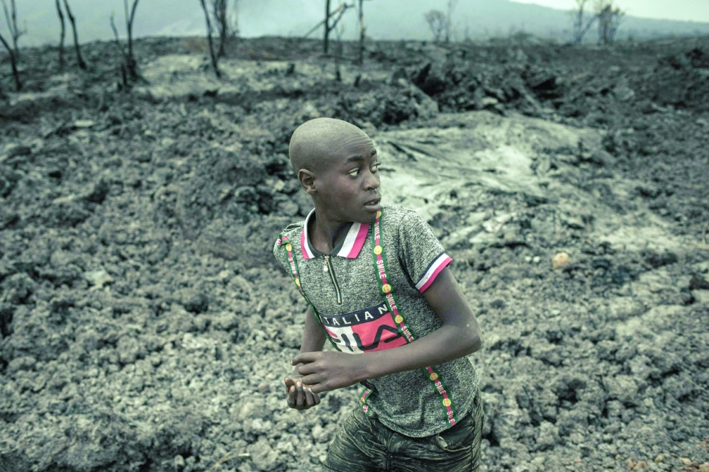 A child runs on the solidified lava flow of the Nyiragongo volcano in the northern neighbourhoods of Goma, the provincial capital of North Kivu. - AFP