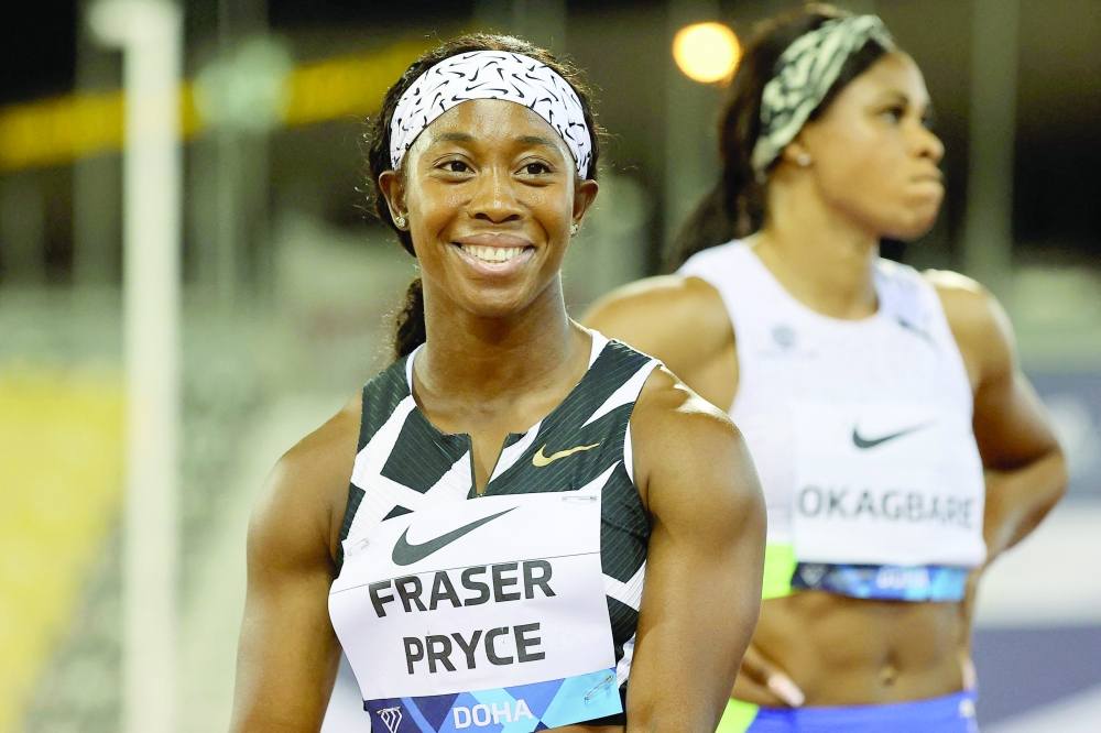 Jamaica's Shelly-Ann Fraser-Pryce celebrates after winning the women's 100m final during the Diamond League athletics at the Qatar Sports Club stadium in Doha. -- AFP
