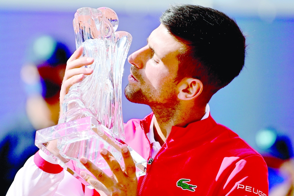 Serbia's Novak Djokovic kisses the trophy after winning the final against Slovakian Alex Molcan in Belgrade. -- AFP
