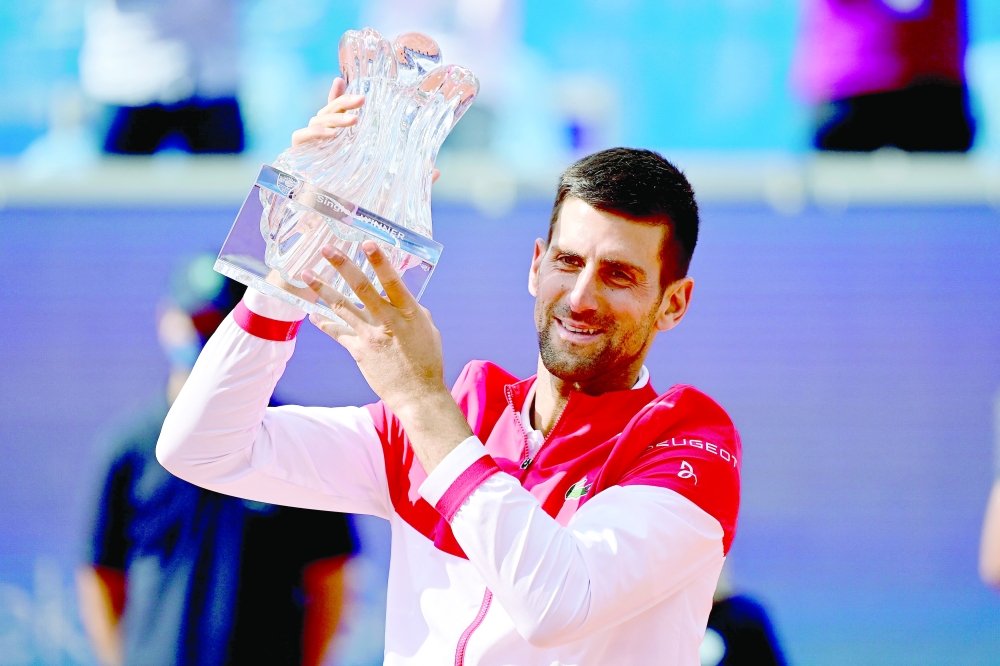 Serbia's Novak Djokovic holds the trophy after winning the final against Slovakian Alex Molcan in Belgrade. -- AFP
