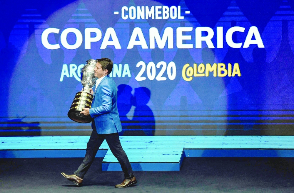 In this file photo taken on December 03, 2019 Brazilian former footballer Juninho Paulista presents the Copa America trophy on the stage during the draw of the Copa America 2020. -- AFP

