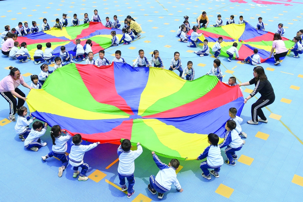 Children play at a kindergarten in Yantai in China's eastern Shandong province. - AFP
