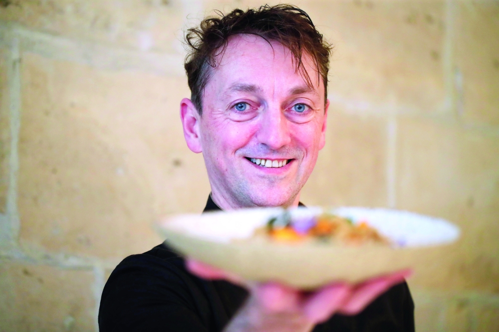 French chef Laurent Veyet displays a dish as he poses in his restaurant Inoveat serving insect-based food in Paris. — Reuters

