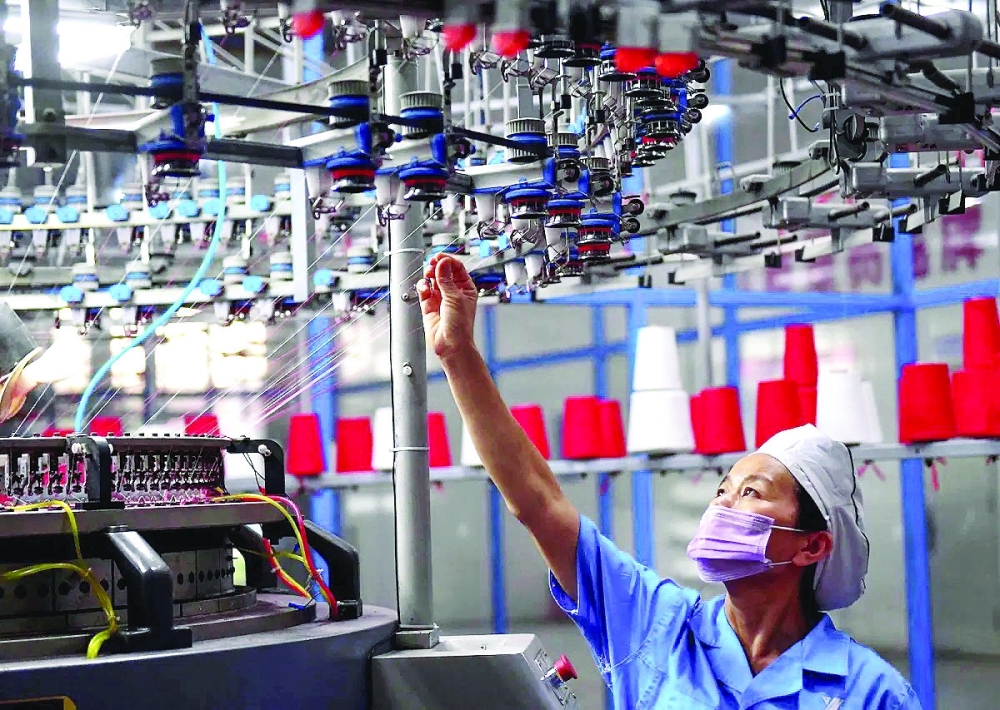 An employee is seen working at a textile factory in Hanoi, Vietnam. — Reuters