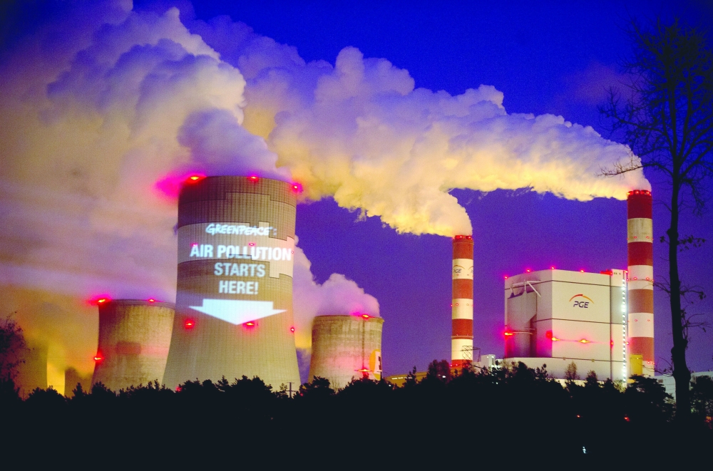 Greenpeace activists project a slogan onto the cooling tower of the brown coal fired Belchatow power plant, in Belchatow, Poland. 