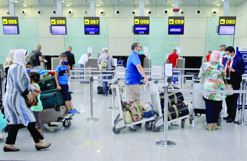 Passengers wait to check-in at an Air France counter for a flight to Paris at Algiers' Houari Boumediene Airport on Tuesday, after Algeria reopened its borders following a 15-months closure due to the Covid-19 pandemic. — AFP