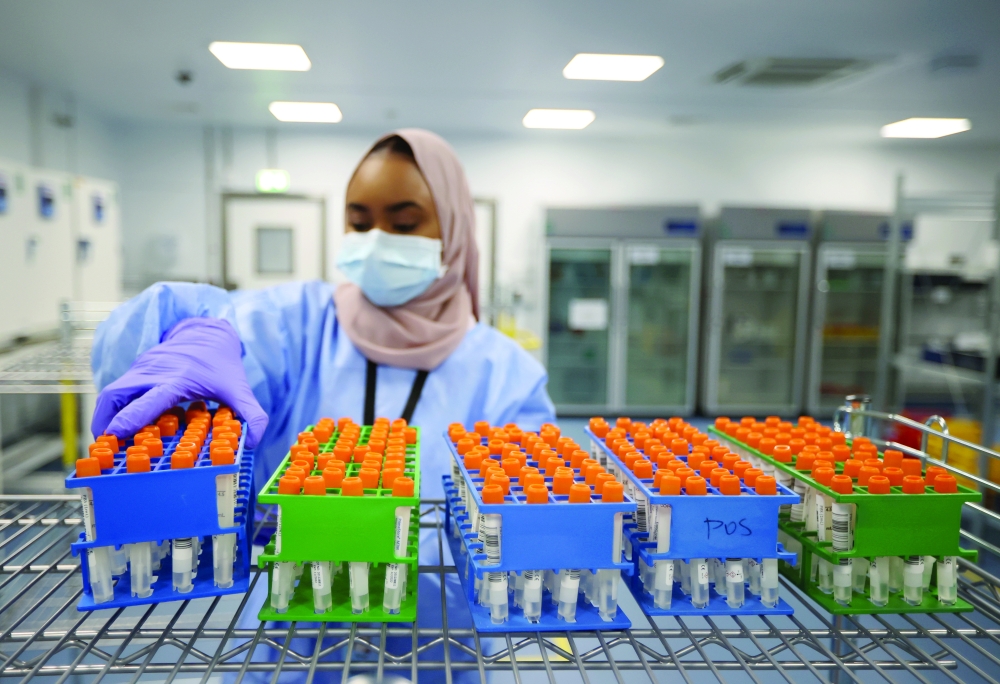 A lab technician works at the Amazon Covid-19 testing lab in Worsley, Britain. - Reuters 