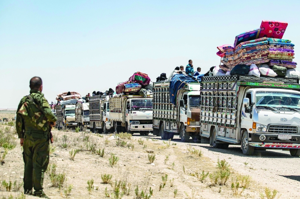 Syrian families sit in a truck after being released from the Kurdish-run Al-Hol camp, which holds relatives of suspected IS group fighters, in the northeastern Syrian Hasakeh governorate, on Wednesday. — AFP
