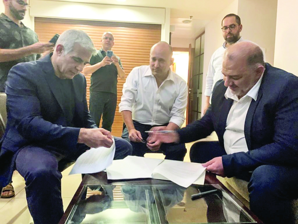 United Arab List party leader Mansour Abbas, Yamina party leader Naftali Bennett and Yesh Atid party leader Yair Lapid, sit together in Ramat Gan, near Tel Aviv on Wednesday. — Reuters