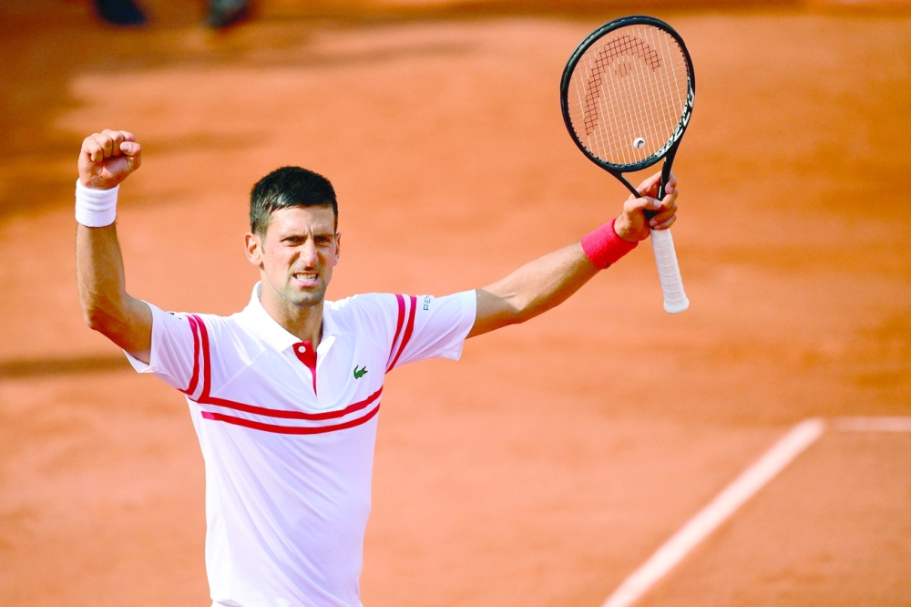 Serbia's Novak Djokovic celebrates after winning against Uruguay's Pablo Cuevas during their men's singles second round tennis match on Day 5 of The Roland Garros 2021 French Open tennis tournament in Paris on June 3, 2021. / AFP / Martin BUREAU

