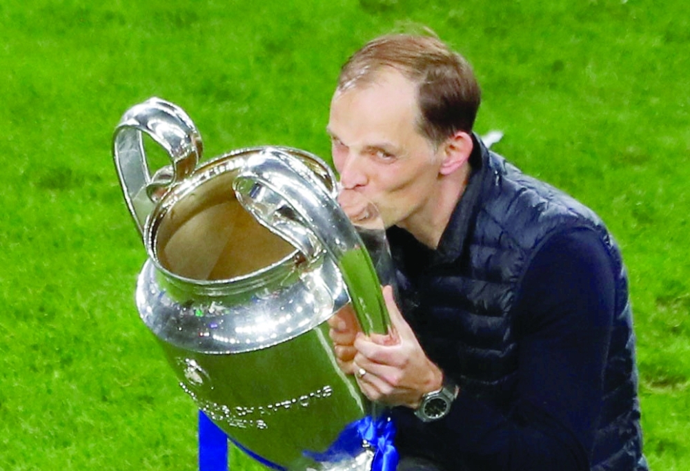 Chelsea manager Thomas Tuchel celebrates with the trophy after winning the Champions League. --Reuters