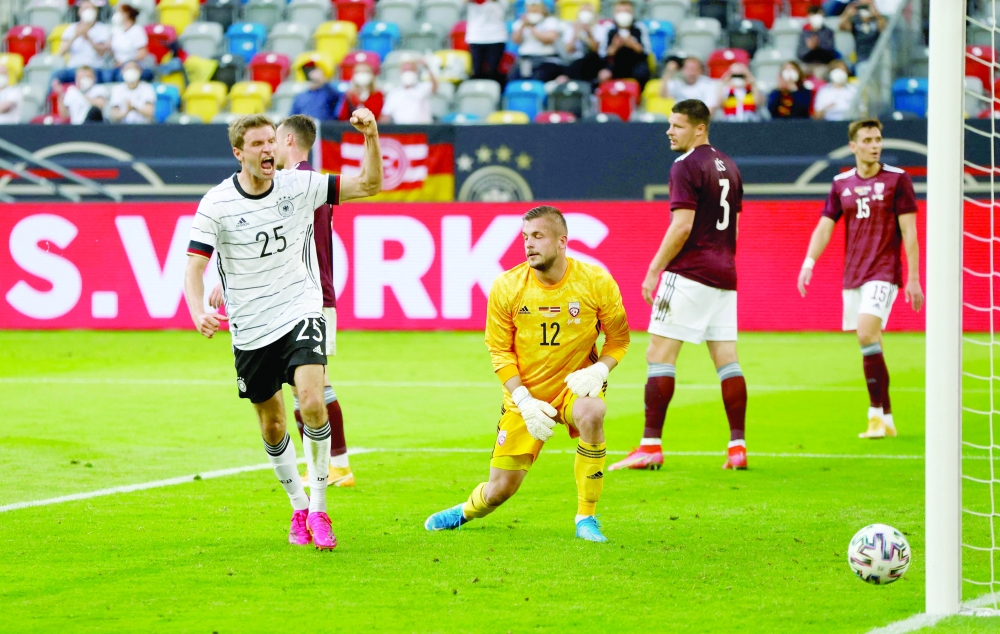 Germany's Thomas Mueller celebrates after scoring the 3-0 goal during the friendly against Latvia in Dusseldorf, western Germany. -- AFP