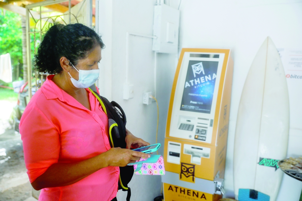 A woman tries to make a Bitcoin transaction at a Bitcoin support office at El Zonte Beach in Chiltiupan, El Salvador on Tuesday. — Reuters
