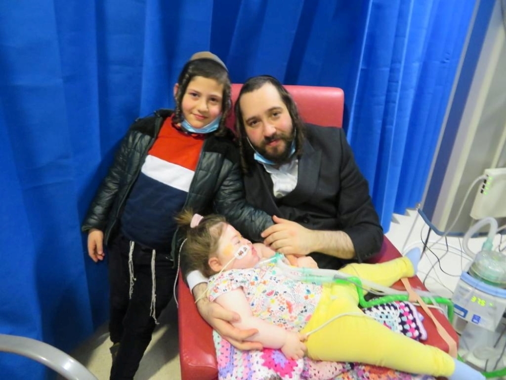 Alta is seen with her brother Tzvi and father Abraham, in Manchester.— AFP