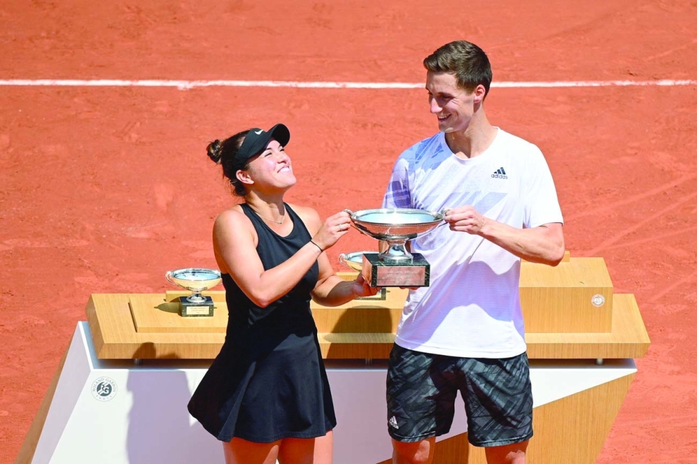 Desirae Krawczyk of the US (L) and Britain's Joe Salisbury celebrate with the trophy after winning their mixed doubles final. -- AFP