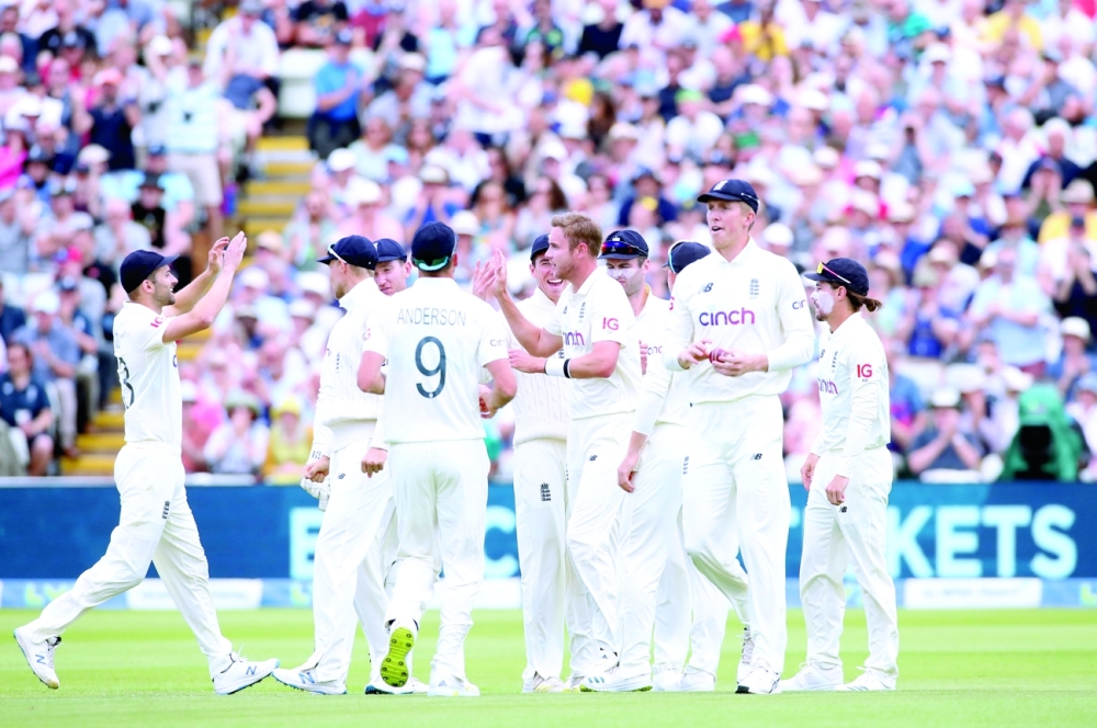 England's Stuart Broad celebrates with team-mates after taking the wicket of New Zealand's Tom Latham. -- Reuters