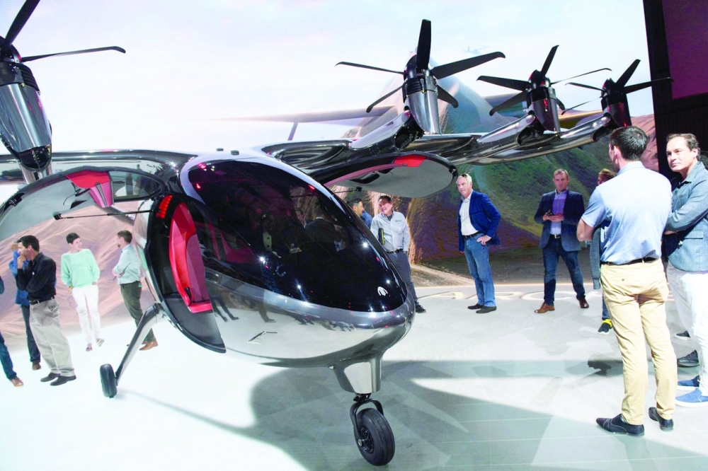 Attendees stand under the wings of the Archer Maker after its unveiling in Hawthorne, California. - AFP