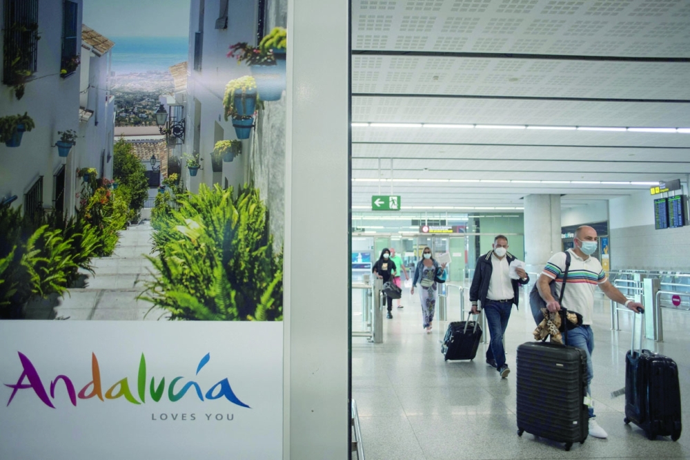 Tourists arrive at Malaga-Costa del Sol Airport in Malaga, Spain. - AFP  