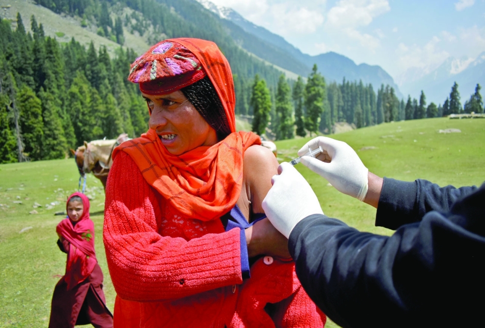 A shepherd woman receives a dose of vaccine during a vaccination drive at Lidderwat near scenic Pahalgam in south Kashmir's Anantnag district. - Reuters