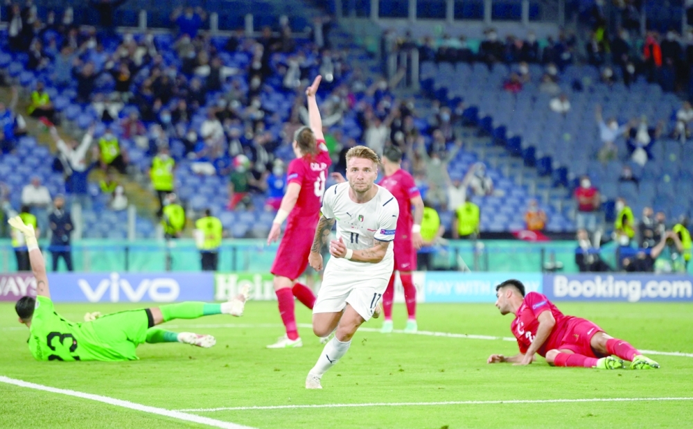 Italy's Ciro Immobile celebrates scoring their second goal. -- Reuters