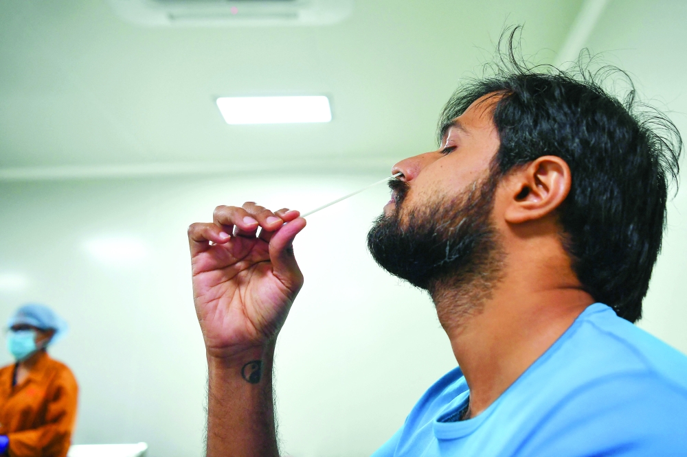 Dr Vikas Ghattargi, demonstrates a Coviself Rapid Antigen Test self kit at the Mylab Discovery Solutions manufacturing facility in Lonavla, south-east of Mumbai. - AFP 
