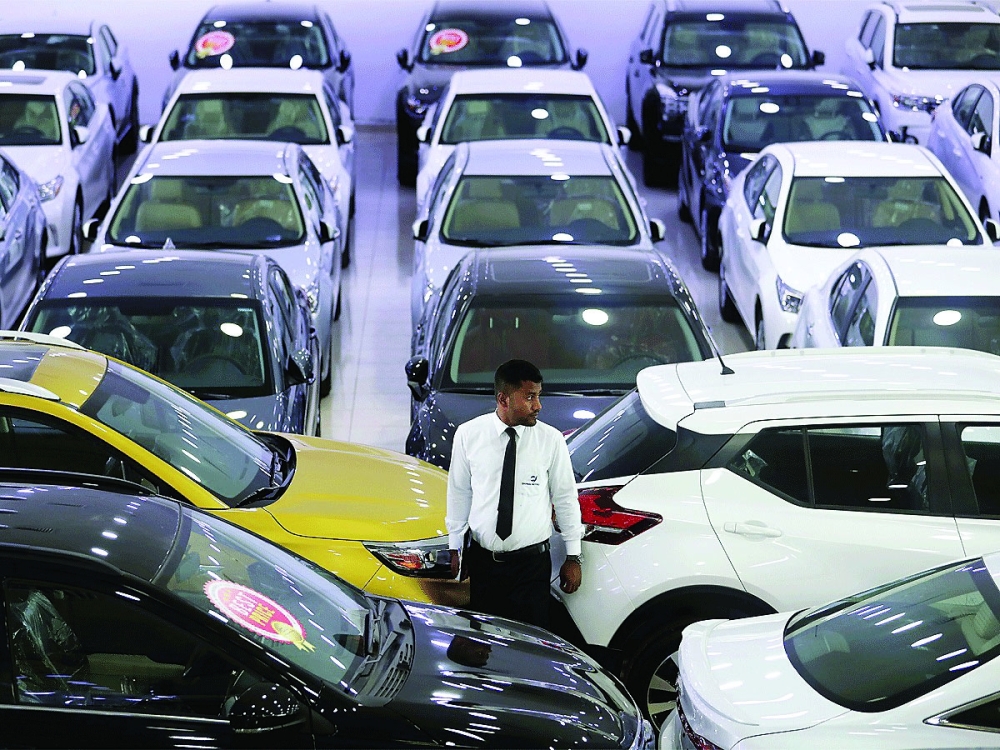 A car salesman is seen inside a car showroom in Jakarta, Indonesia. — Reuters