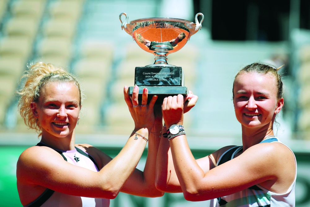 Tennis - French Open - Roland Garros, Paris, France - June 13, 2021 Czech Republic's Barbora Krejcikova and Katerina Siniakova celebrate with trophy after winning the women's doubles final against Poland's Iga Swiatek and Bethanie Mattek-Sands of the U.S. REUTERS/Gonzalo Fuentes
