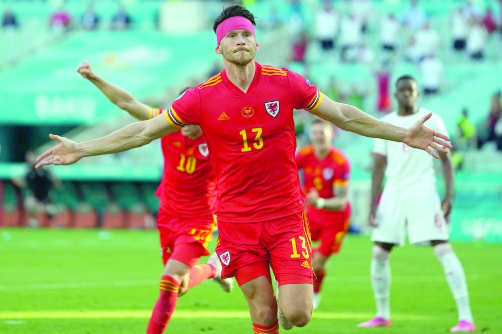 Wales' midfielder Kieffer Moore celebrates after scoring the equaliser. -- AFP 