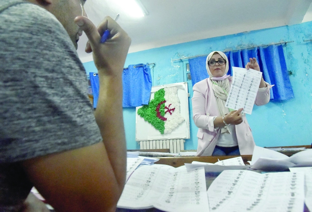 Algerian elections staff count ballots for parliamentary elections at a polling station in Bouchaoui on the western outskirts of Algiers. - AFP 