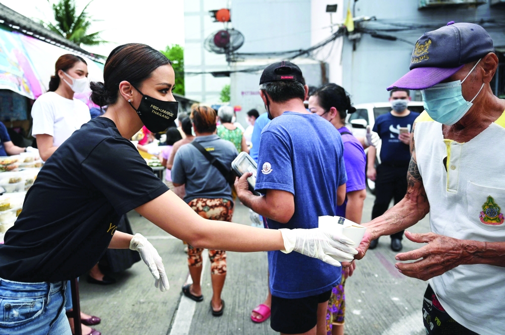 Miss Universe Thailand 202, Amanda Obdam hands food boxes made by Michelin-starred chefs to residents of the Klong Toei slum area in Bangkok. - AFP 
