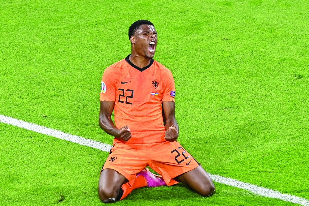 Netherlands' defender Denzel Dumfries celebrates after scoring the third goal. -- AFP 