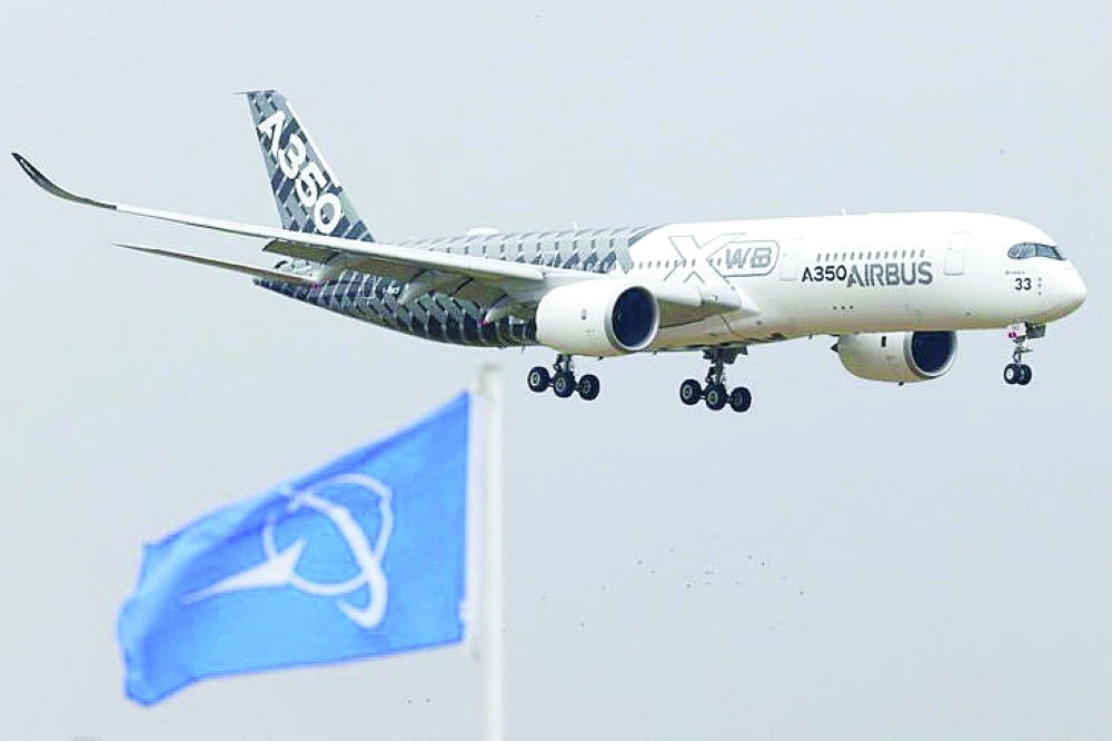 An Airbus A350 jetliner flies over a Boeing flag during an airshow at Le Bourget airport near Paris,  in this file photo. — Reuters