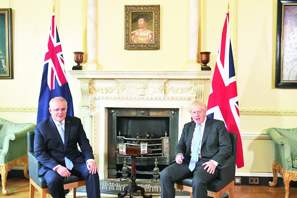 Australia's Prime Minister Scott Morrison and Britain's Prime Minister Boris Johnson speak at 10 Downing Street, ahead of a meeting to formally announce a trade deal, in London, Britain. — Reuters