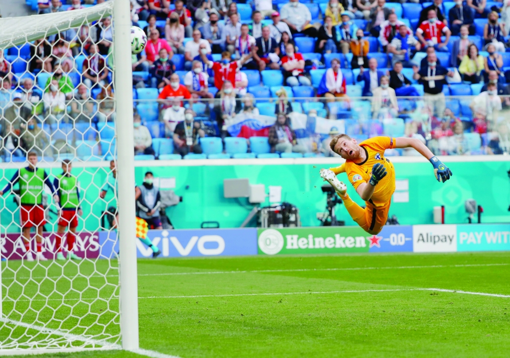 Russia's Aleksei Miranchuk scores their first goal as Finland's Lukas Hradecky attempts a save. -- Reuters