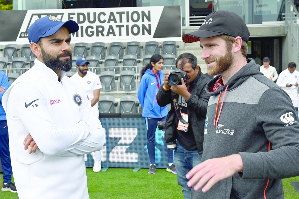 New Zealand captain Kane Williamson (R) talks to India captain Virat Kohli in the file picture. -- AFP