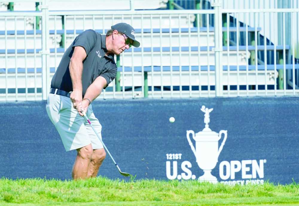 Phil Mickelson chips onto the 11th green during a practice round of the US Open at Torrey Pines. -- USA Today Sports