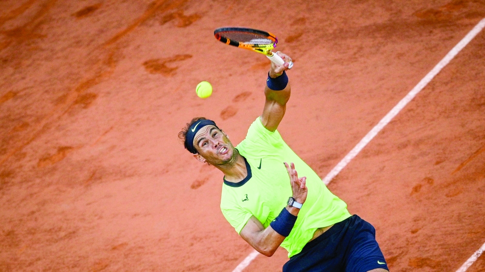 Spain's Rafael Nadal serves the ball to Serbia's Novak Djokovic during their semifinal at the 2021 French Open in Paris. -- AFP