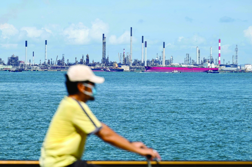 The Shell petroleum refinery off Bukom island is seen in the background in Singapore. - AFP