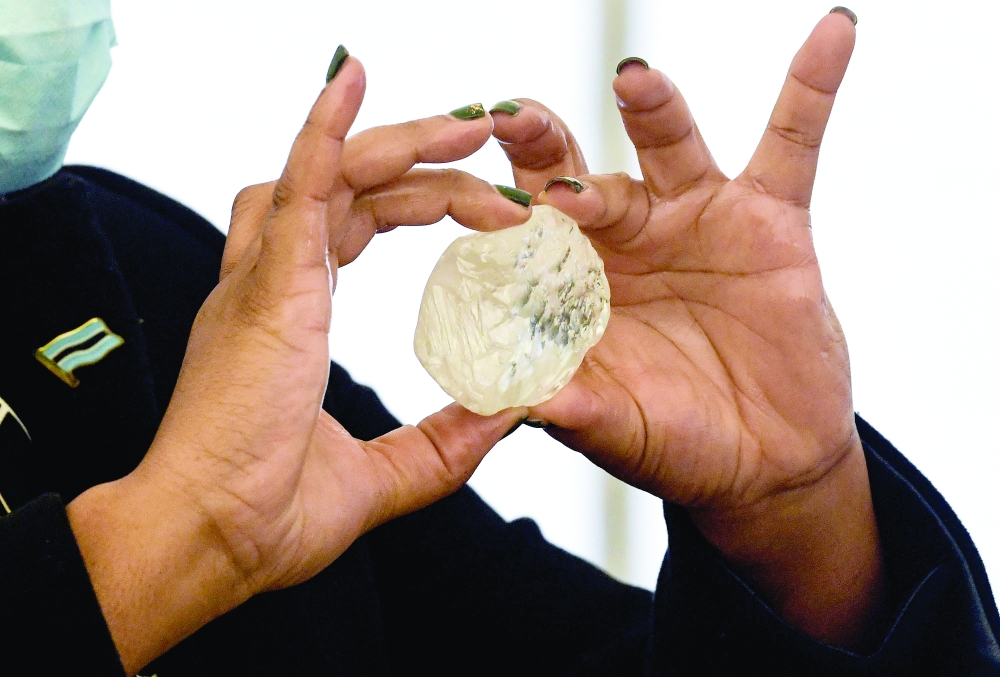 A Botswana minister holds a gem diamond in Gaborone on Wednesday. — Reuters