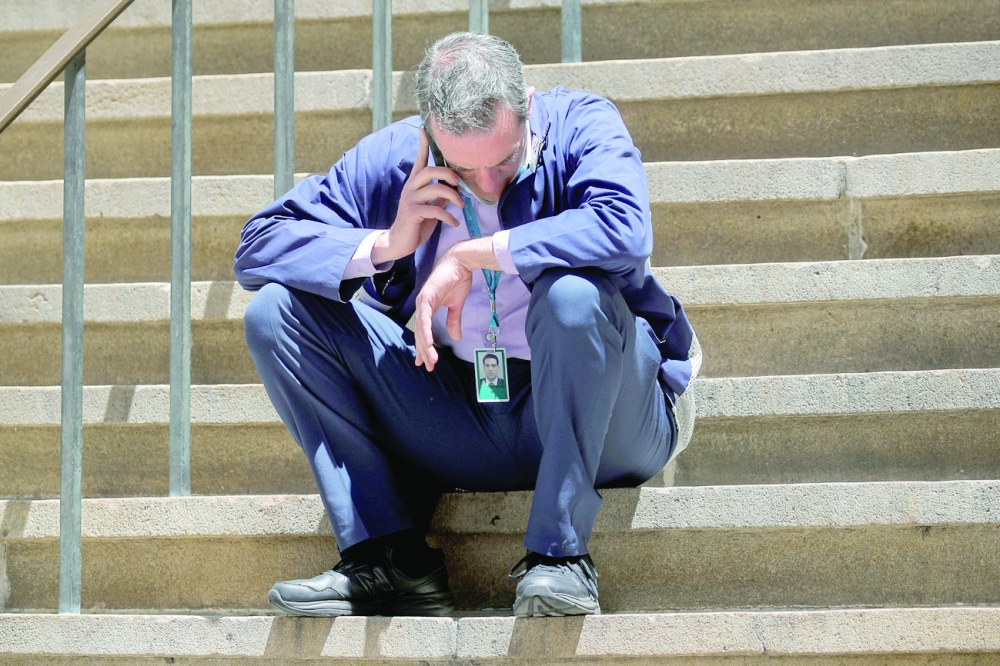 Trader Greg Rowe talks on his phone during a break outside of the New York Stock Exchange (NYSE) on Wall Street in New York City. - Reuters
