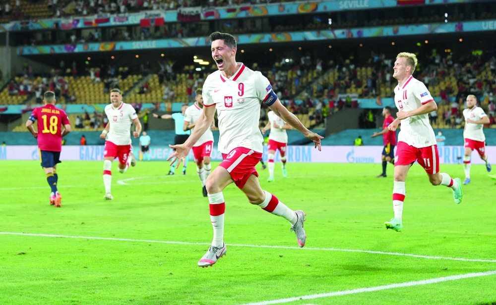 Poland's Robert Lewandowski celebrates scoring their first goal. -- Reuters