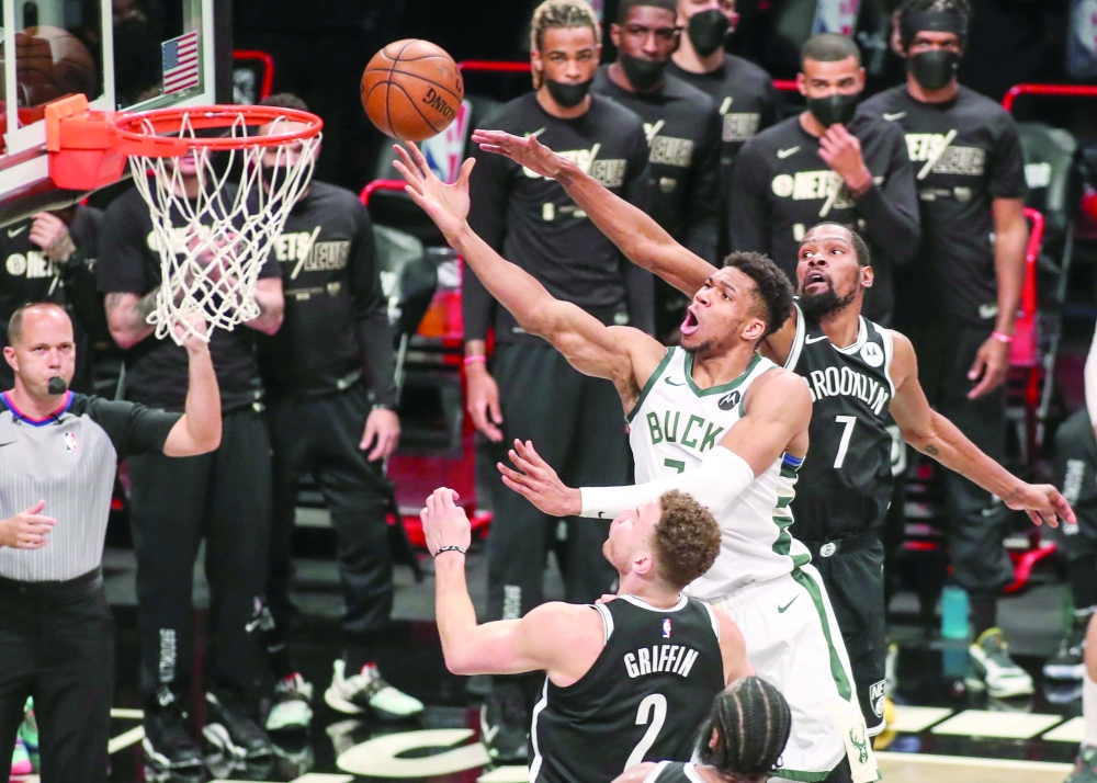 Milwaukee Bucks forward Giannis Antetokounmpo (34) drives past Brooklyn Nets forward Kevin Durant (7) for a layup. -- USA Today Sports