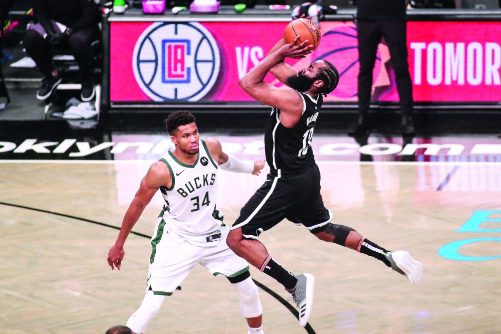 Brooklyn Nets guard James Harden (13) shoots an off balanced shot over Milwaukee Bucks forward Giannis Antetokounmpo (34) in overtime. -- USA Today Sports