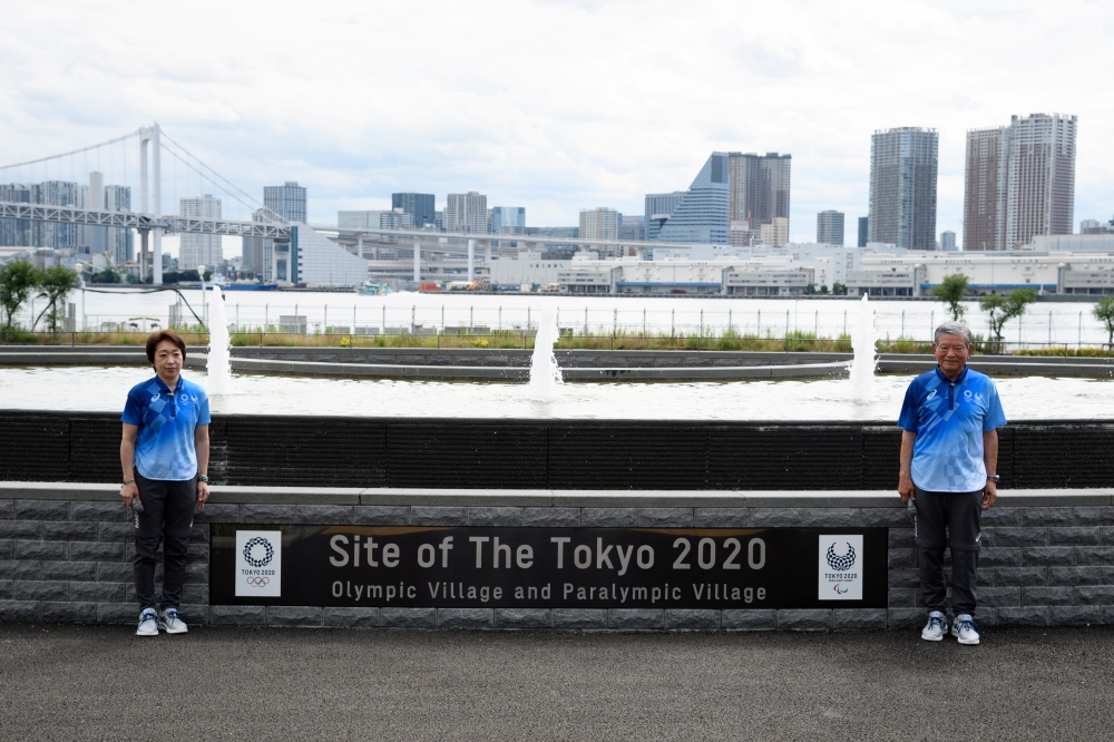 Tokyo Olympics Organising Committee president Seiko Hashimoto and Olympic Village mayor Saburo Kawabuchi pose for a photograph during a media tour at the Olympic and Paralympic Village for the Tokyo 2020 Games