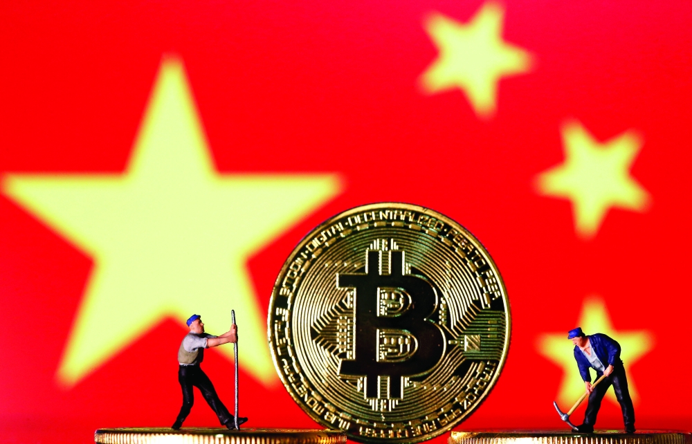 Small toy figurines and representations of the Bitcoin virtual currency are seen in this illustration picture. — Reuters
