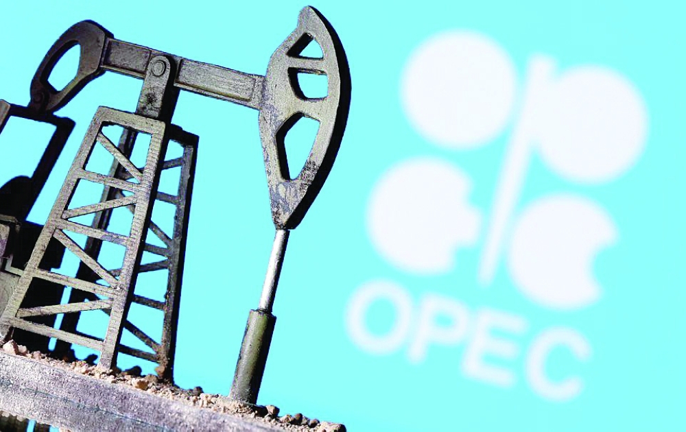 A 3D-printed oil pump jack is seen in front of displayed OPEC logo in this illustration picture.  — Reuters